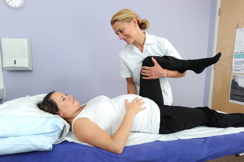 Osteopath treating a pregnant lady
